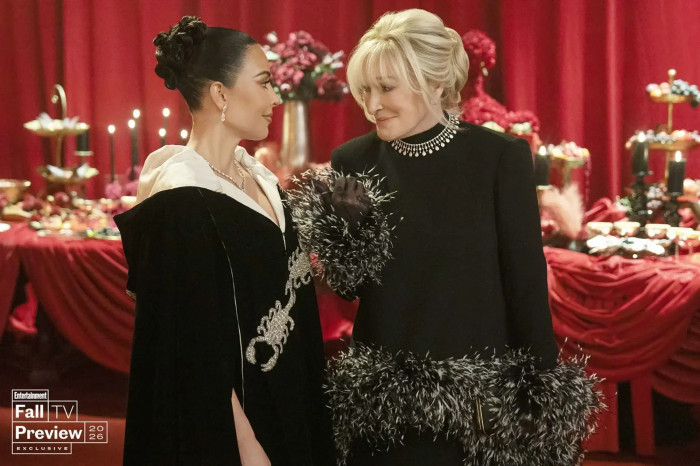 Kim Kardashian and Glenn Close in formal black outfits with dramatic decorations in a scene from