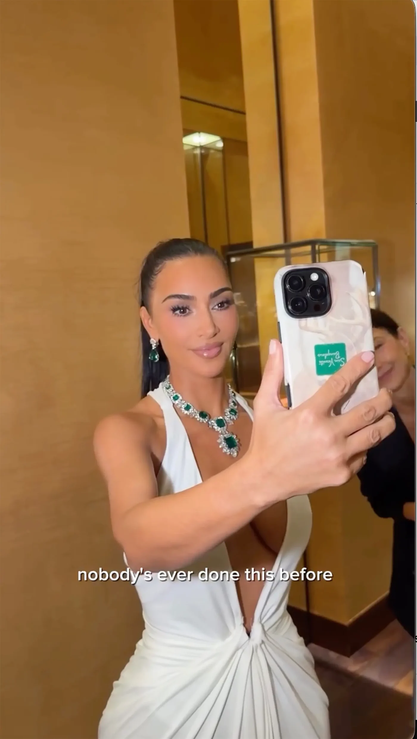 Kim Kardashian taking a selfie wearing Elizabeth Taylor