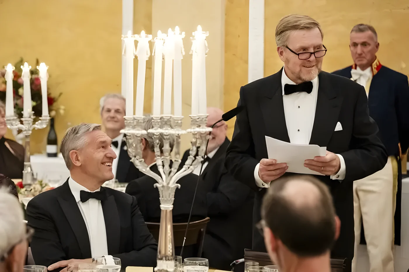 King Willem-Alexander speaks next to Vice-President of the Council of State Sybrand Buma during a dinner