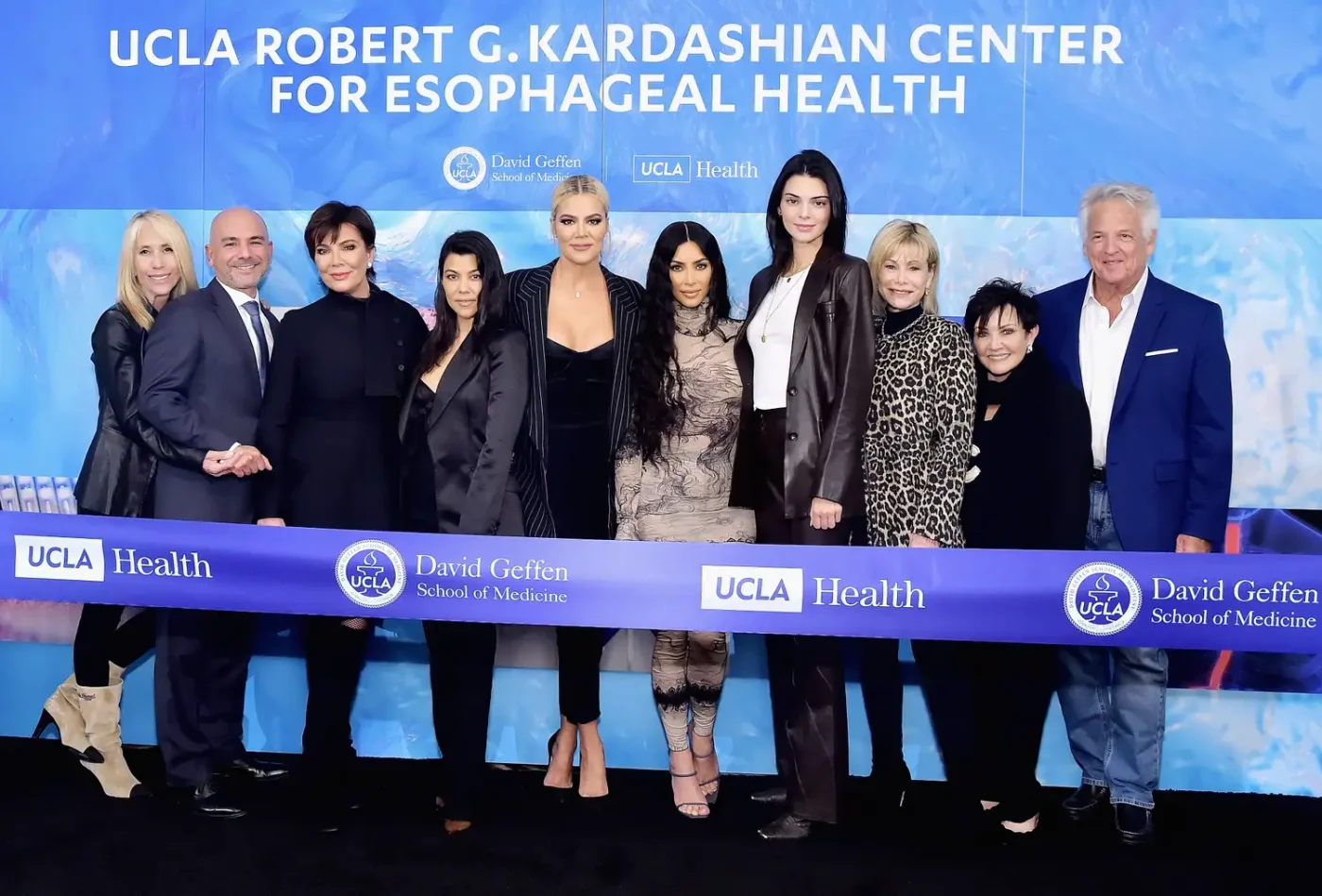Kris Jenner Carmen Russo and Kendall Jenner with a group at a ribboncutting event