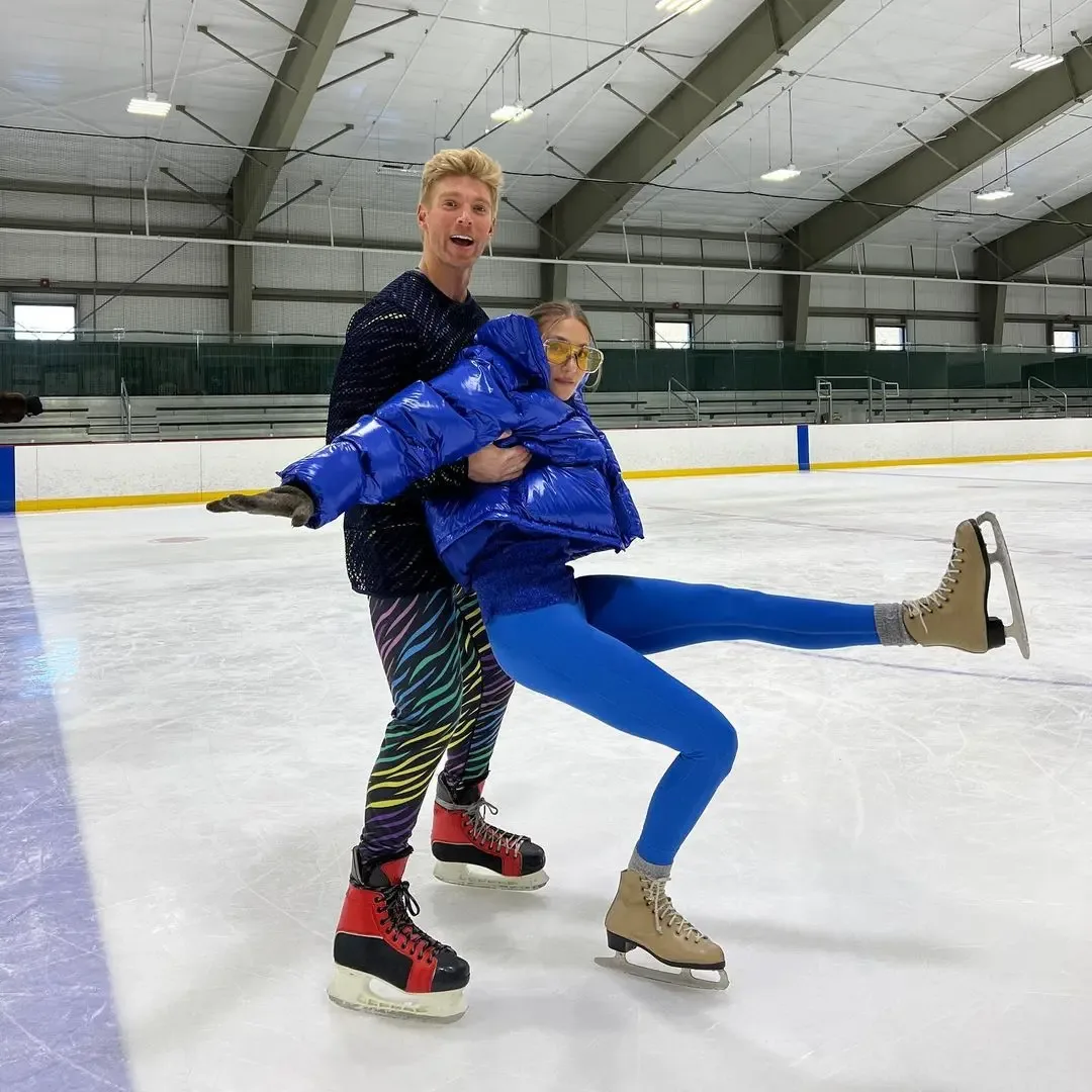 Kyle Cooke and Amanda Batula ice skating together.