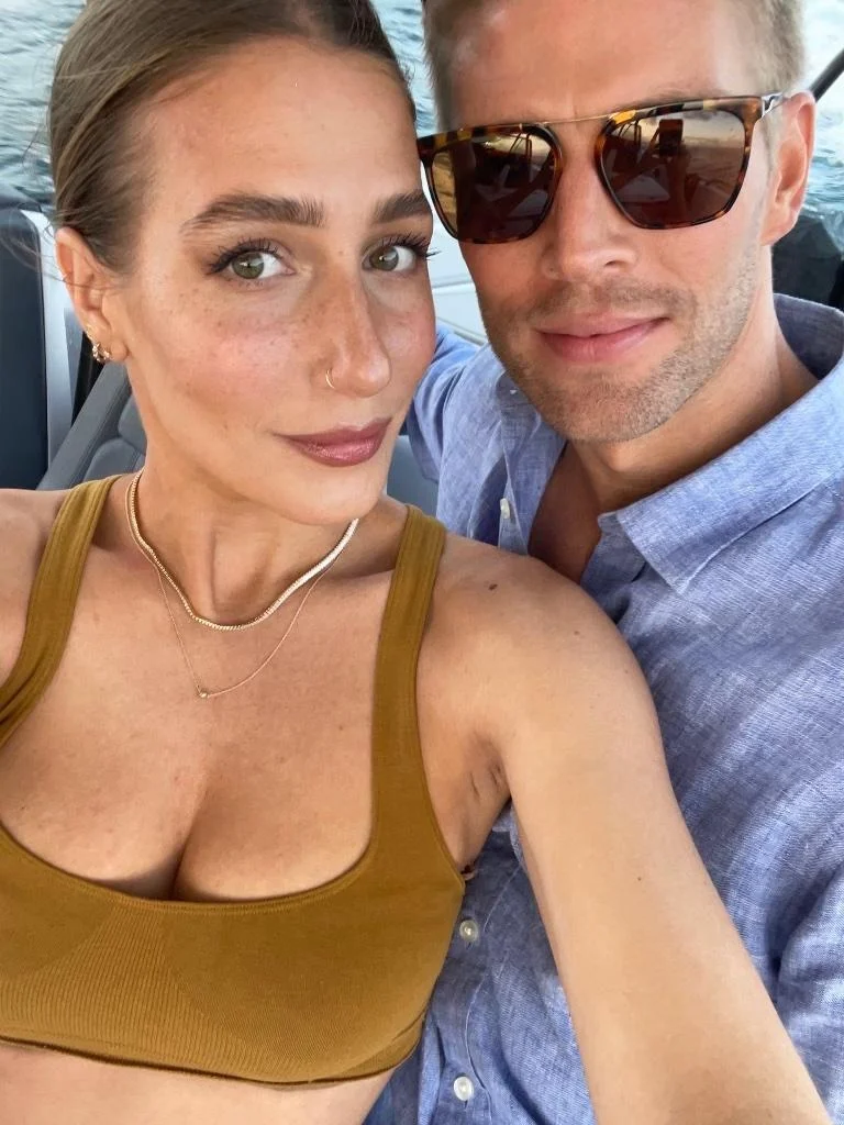 Kyle Cooke and Amanda Batula taking a selfie on a boat.
