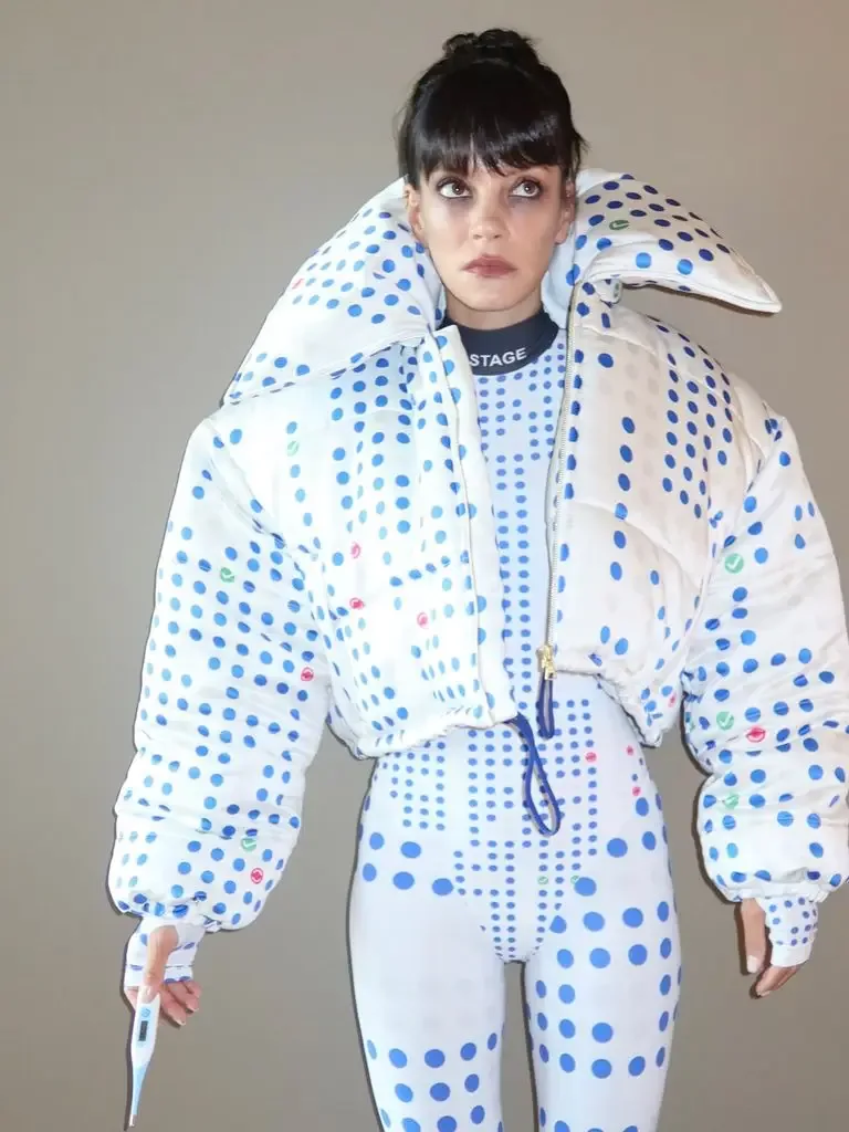 Lily Allen dressed up as a Ticketmaster seat map, covered in blue dots