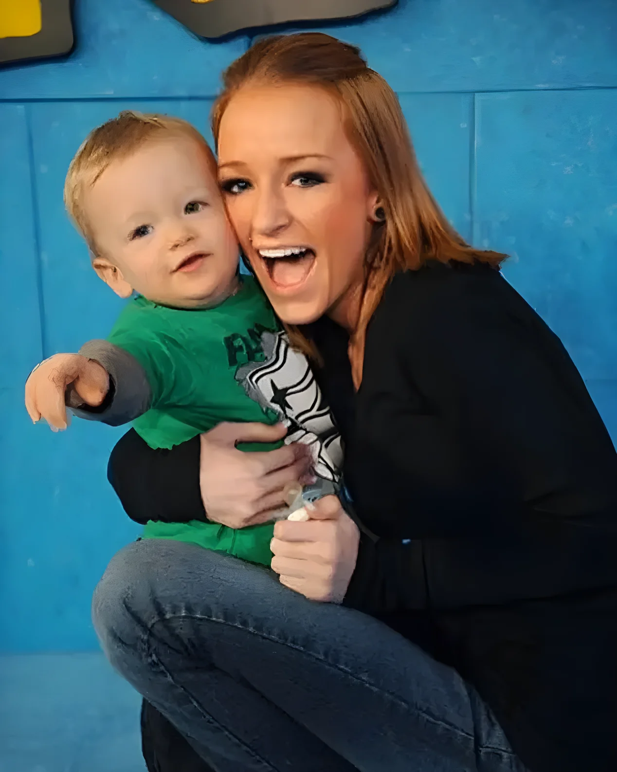 Maci Bookout smiling while holding her son Bentley.