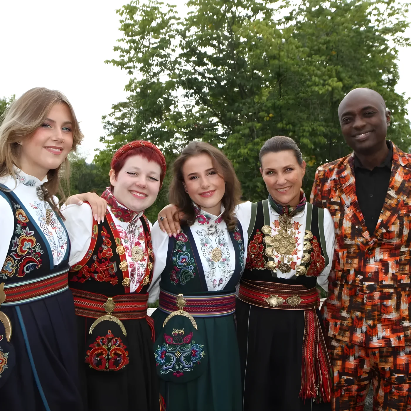 Martha Louise with three daughters in traditional dress and Durek Verrett