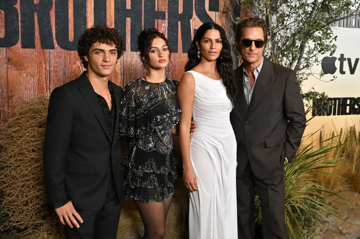 Matthew McConaughey and Camila Alves posing with two other individuals at an event