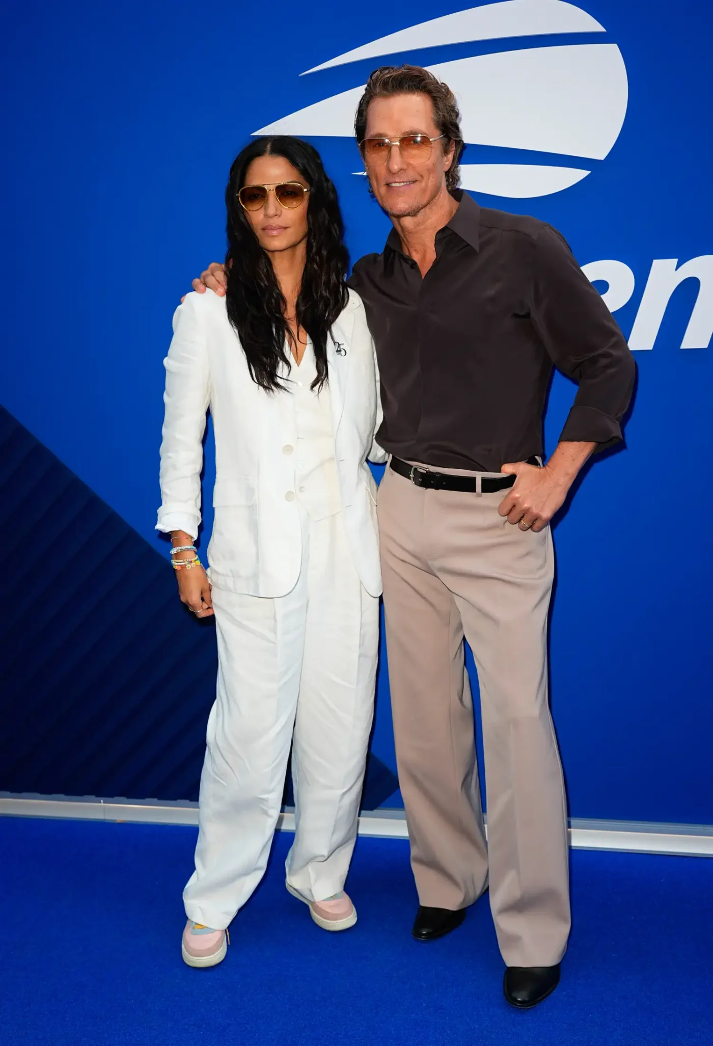 Matthew McConaughey posing with another individual at an event