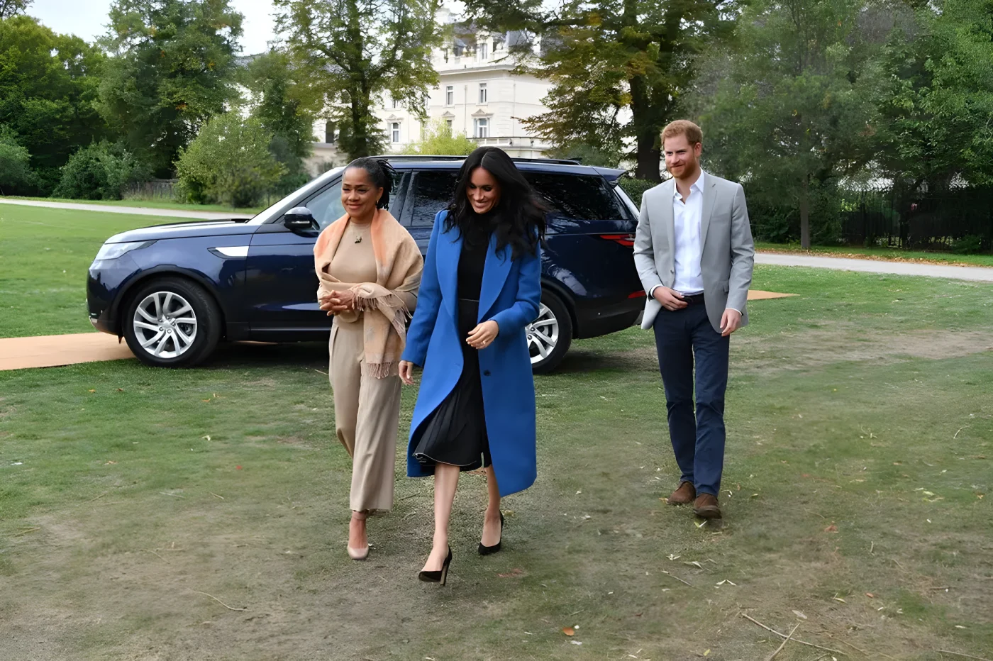 Meghan, Duchess of Sussex (C) arrives with her mother Doria Ragland (L) and Prince Harry, Duke of Sussex to host an event to mark the launch of a cookbook with recipes from a group of women affected by the Grenfell Tower fire at Kensington Palace on September 20, 2018 in London, England.