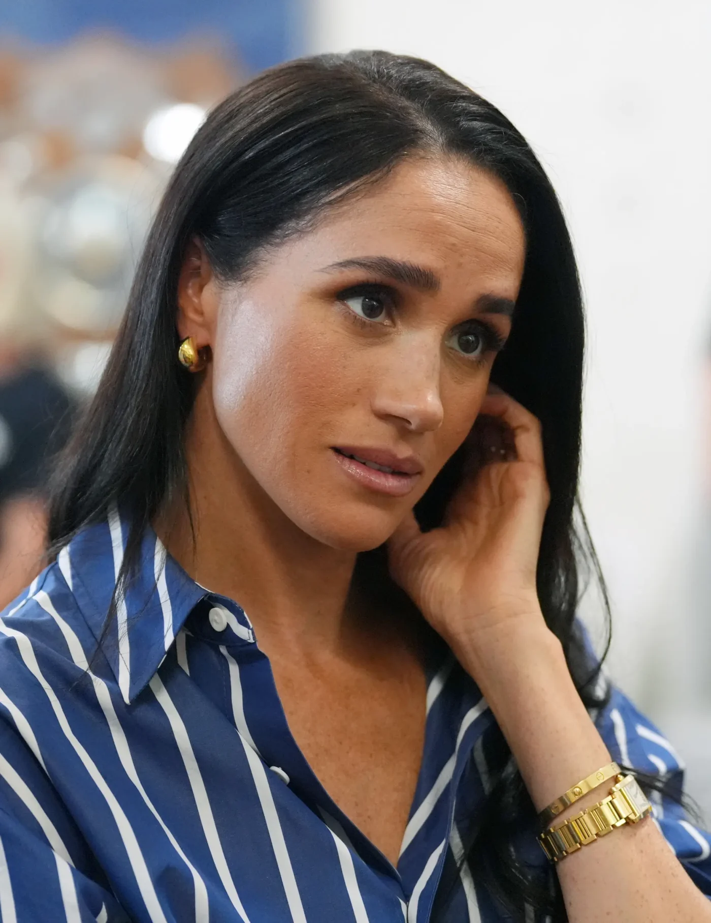 Meghan, Duchess of Sussex, wearing a blue and white striped shirt during a visit to Bondi Beach.