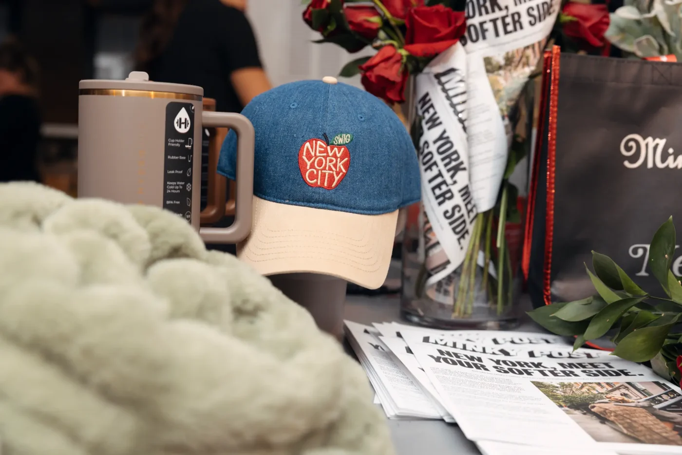 Merchandise display featuring a denim baseball cap with a