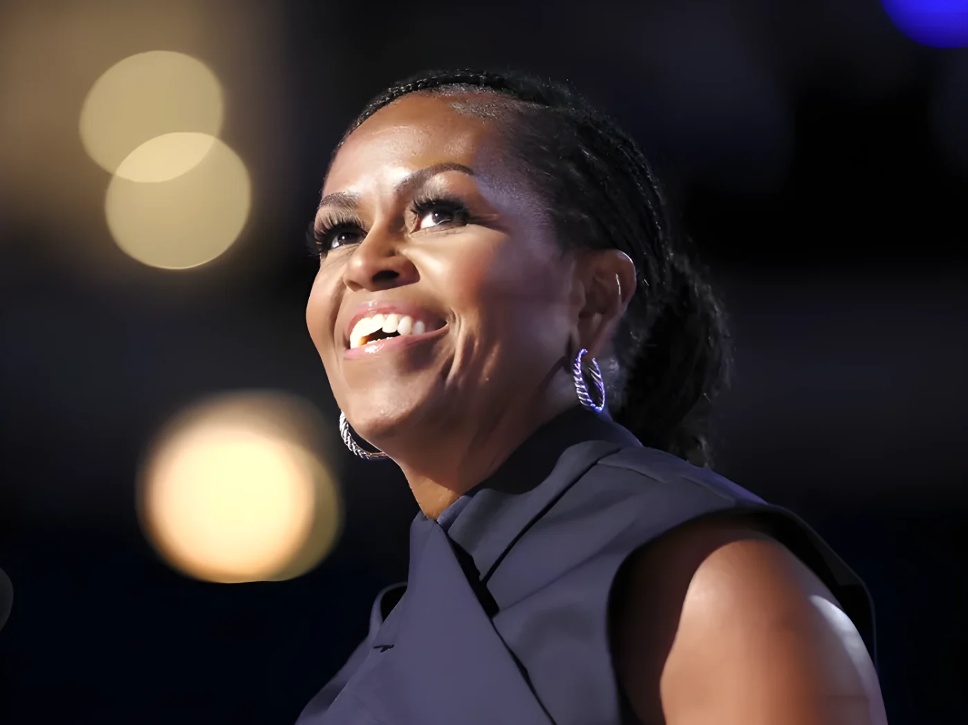 Michelle Obama smiling captured in a closeup during an event