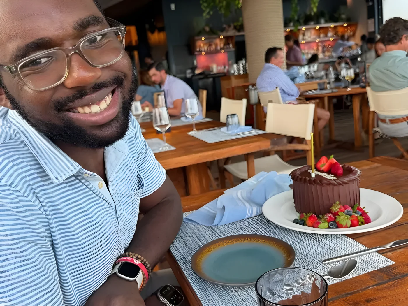 nick roker smiling with birthday cake on a table