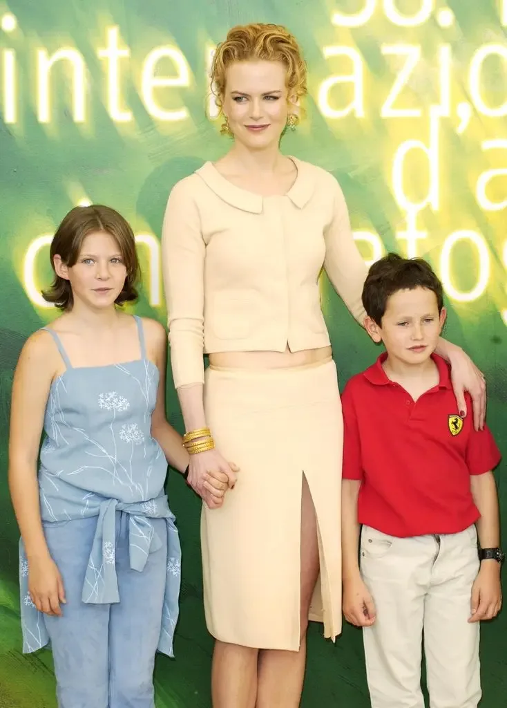 Nicole Kidman stands between young co-stars Alakina Mann and James Bentley, holding hands with Alakina and an arm around James, at a Venice Film Festival photo call.