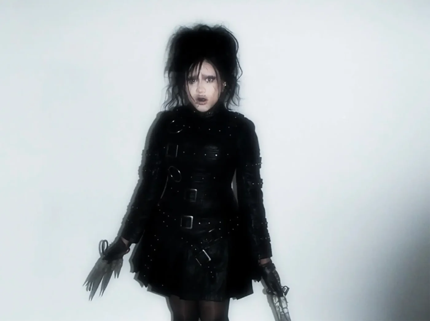 North West dressed as Edward Scissorhands with black leather and wild hair.