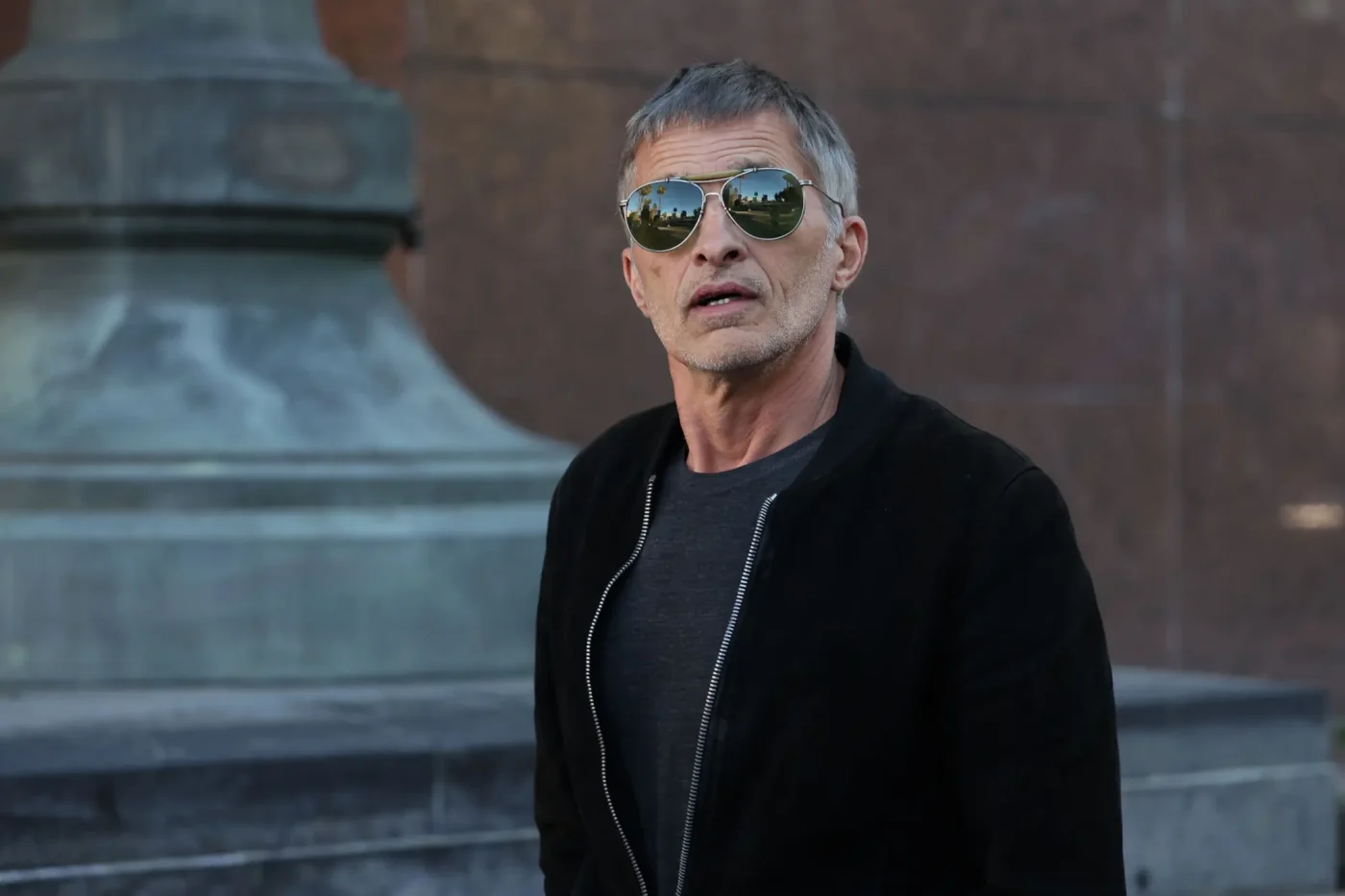 Olivier Martinez wearing sunglasses and a black jacket.