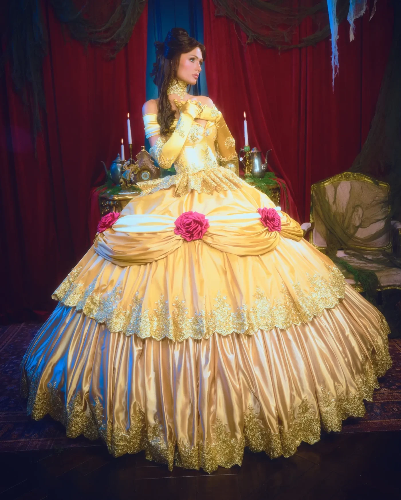 Paris Hilton dressed as Belle from Beauty and the Beast in a yellow ballgown.