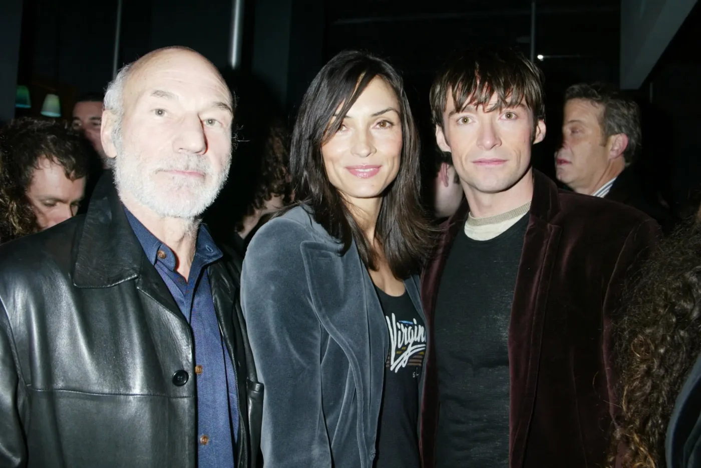 Patrick Stewart, Famke Janssen, and Hugh Jackman pose together at an event.