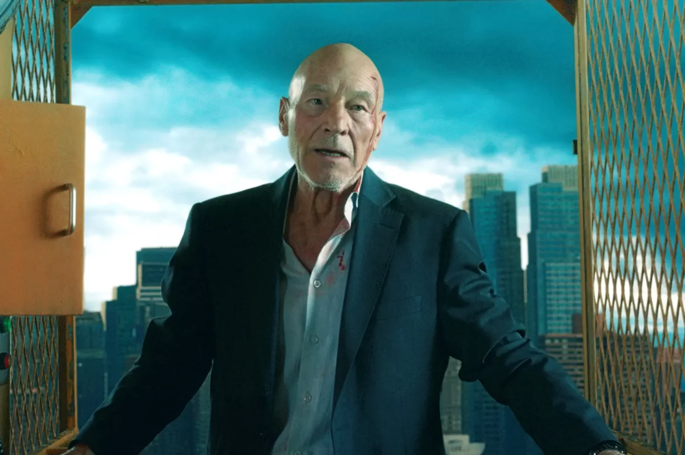 Patrick Stewart in a suit jacket with a bloody face in an elevator, with a cityscape in the background.