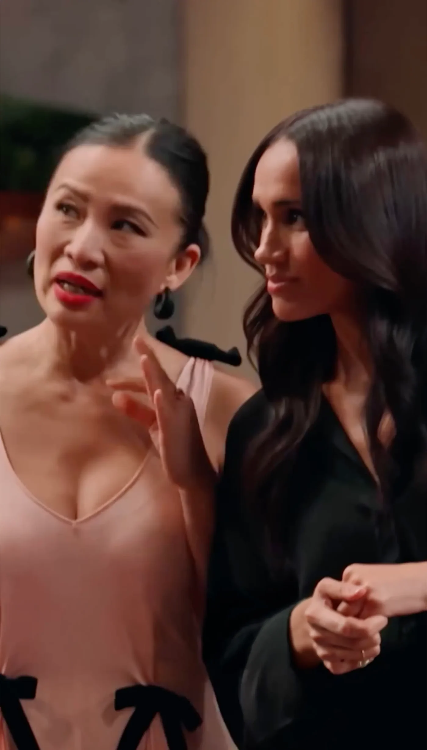 Poh Ling Yeow and Meghan Markle standing together.