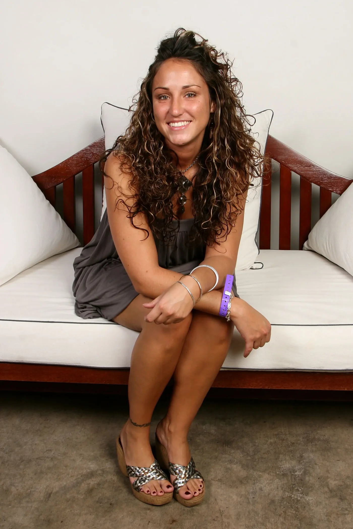 Portrait of Amber Siyavus sitting on a couch.