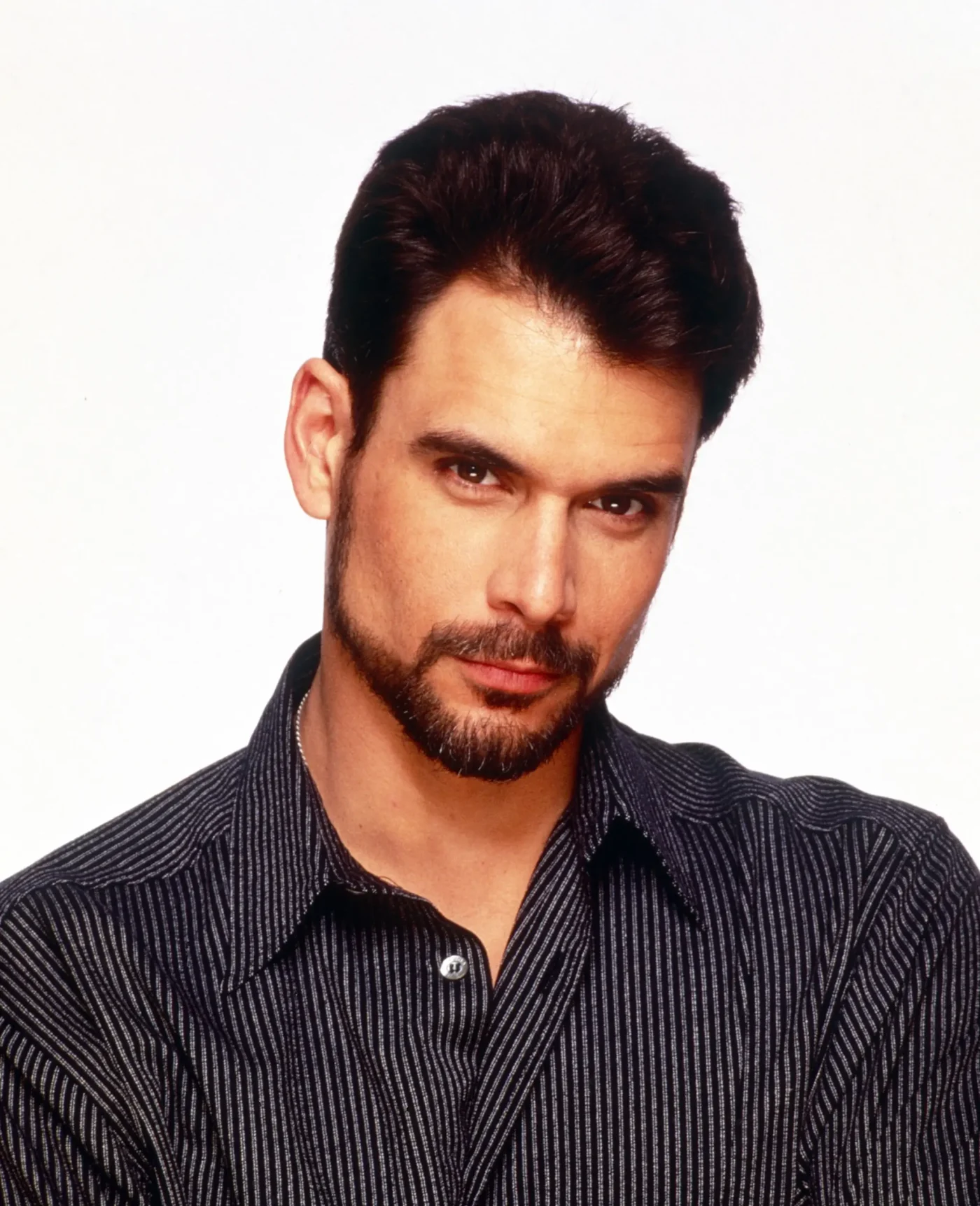 Portrait of Robert Kelker-Kelly wearing a black striped shirt.