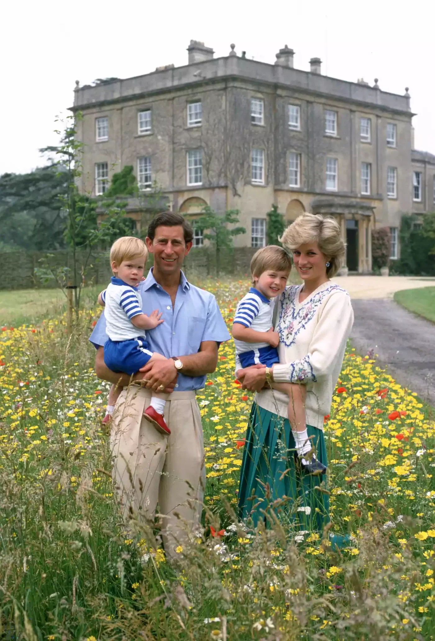 Prince Charles Holding Prince Harry Next to Princess Diana Holding Prince William in Flower Meadow at Highgrove in 1986