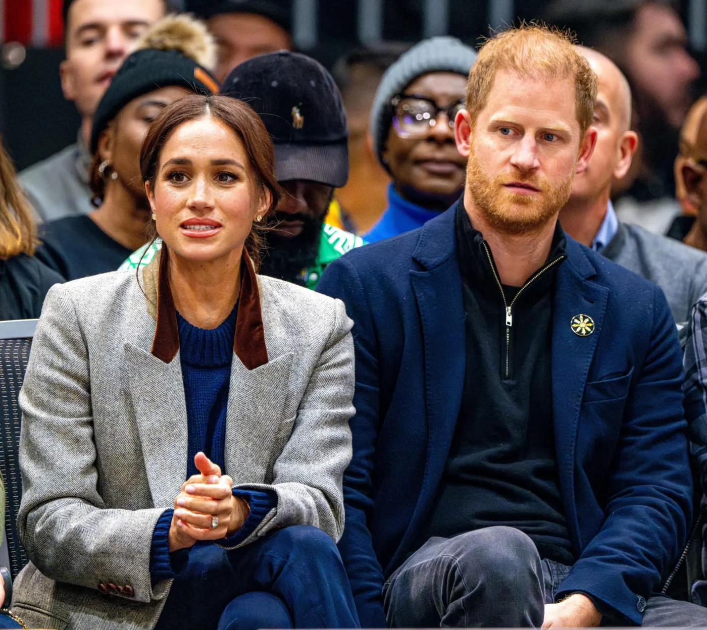 Prince Harry and Meghan Markle sitting together in an audience.