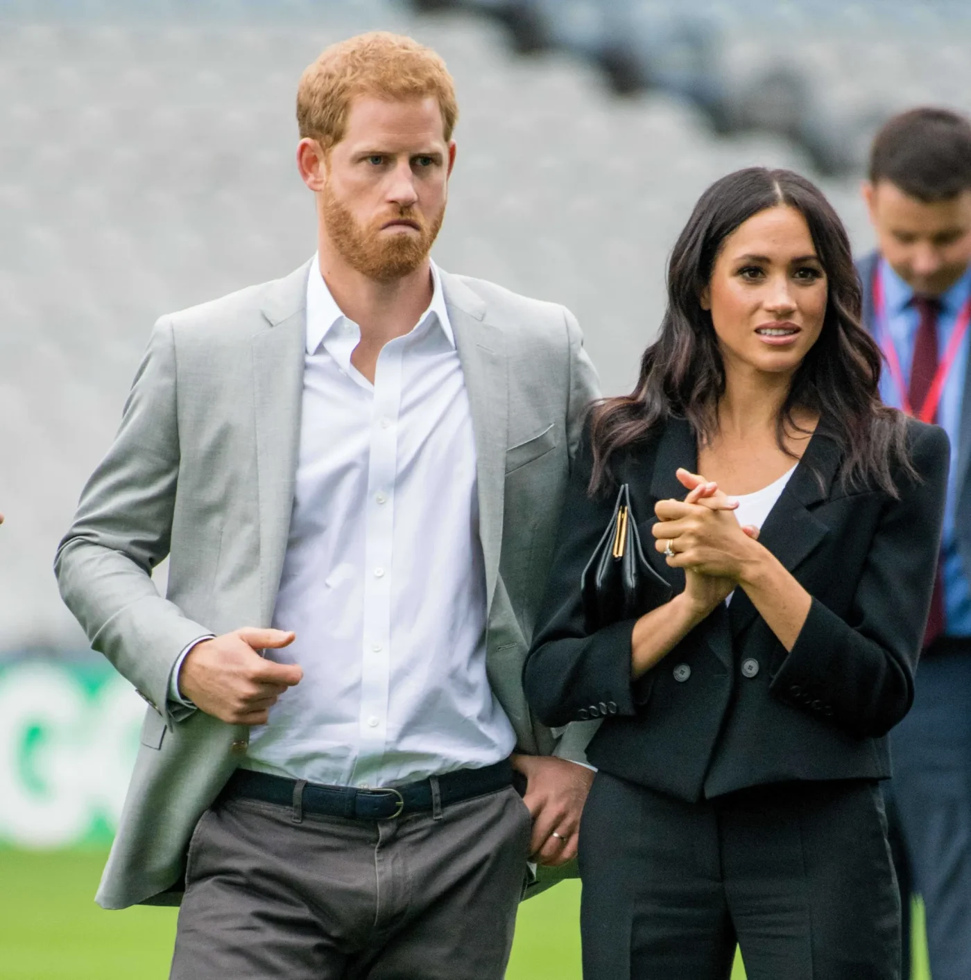 Prince Harry and Meghan Markle standing together outdoors.