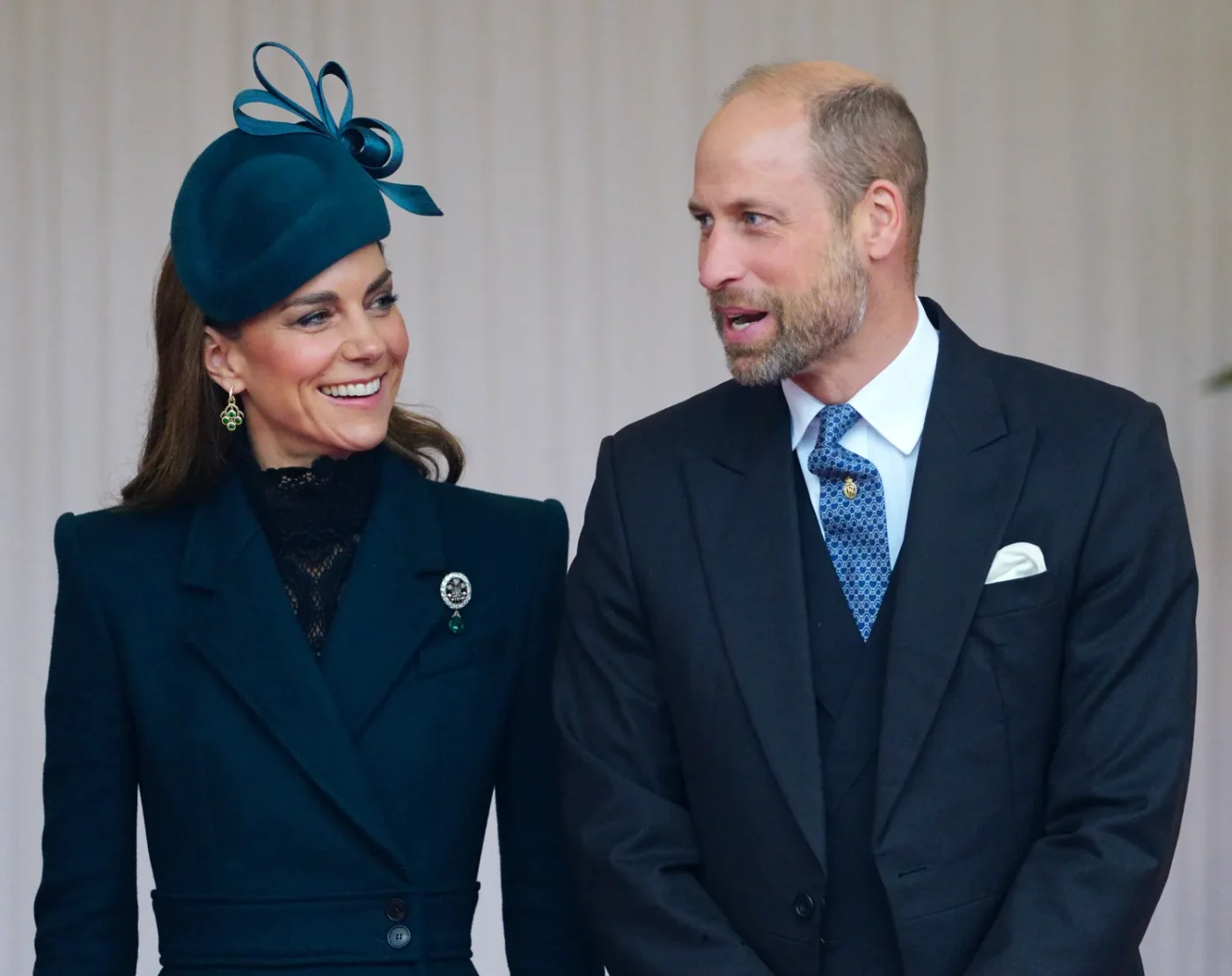 Prince William Duke of Cambridge standing with another individual smiling at an event