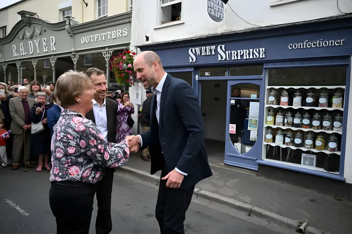 Prince William shakes hands with Jane Morgan, the owner of Sweet Surprise