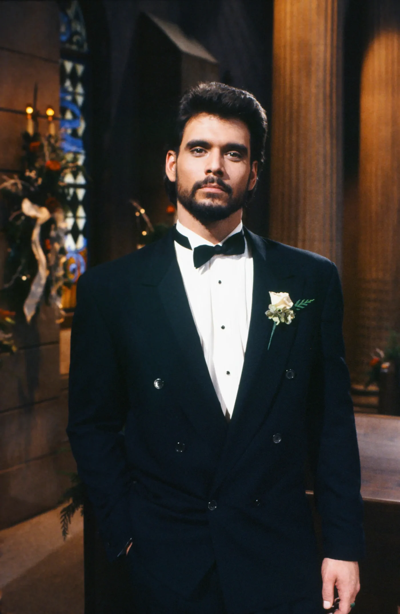 Robert Kelker-Kelly as Bo Brady in Days of Our Lives, wearing a tuxedo with a boutonniere in a church setting.