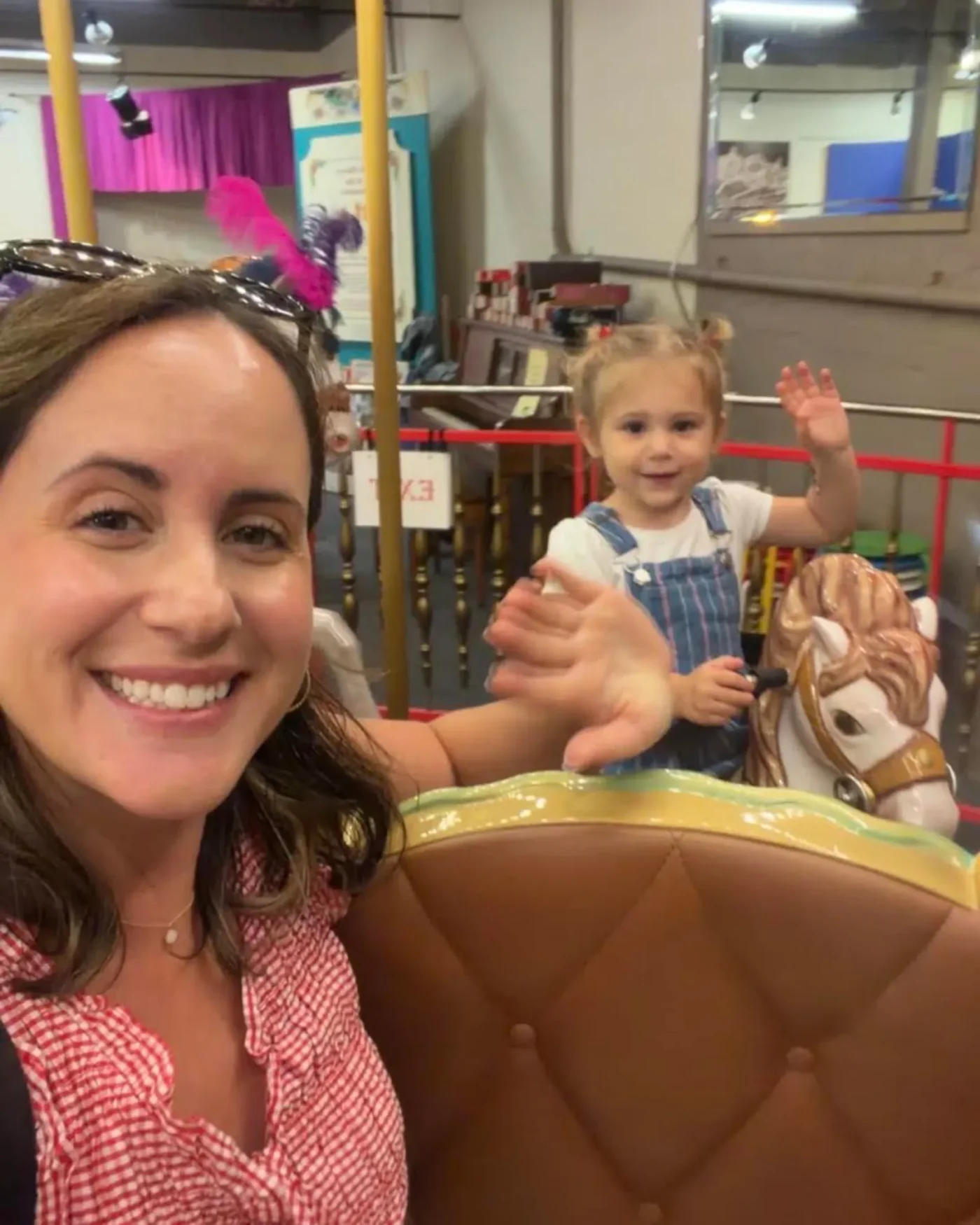 Sarah Sarcone and daughter on a carousel