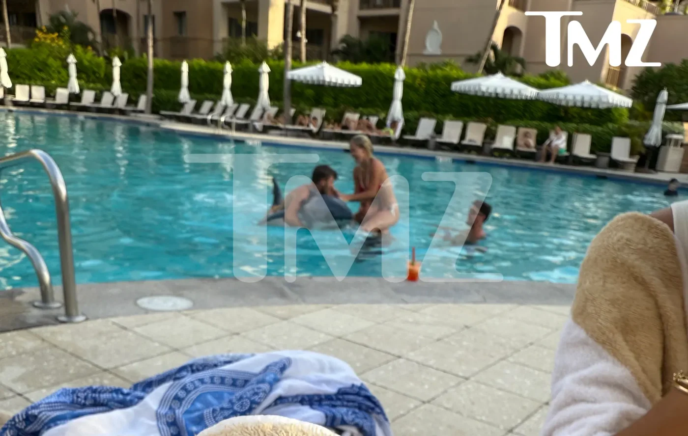 Savannah Chrisley and Jason Galanis by a pool.