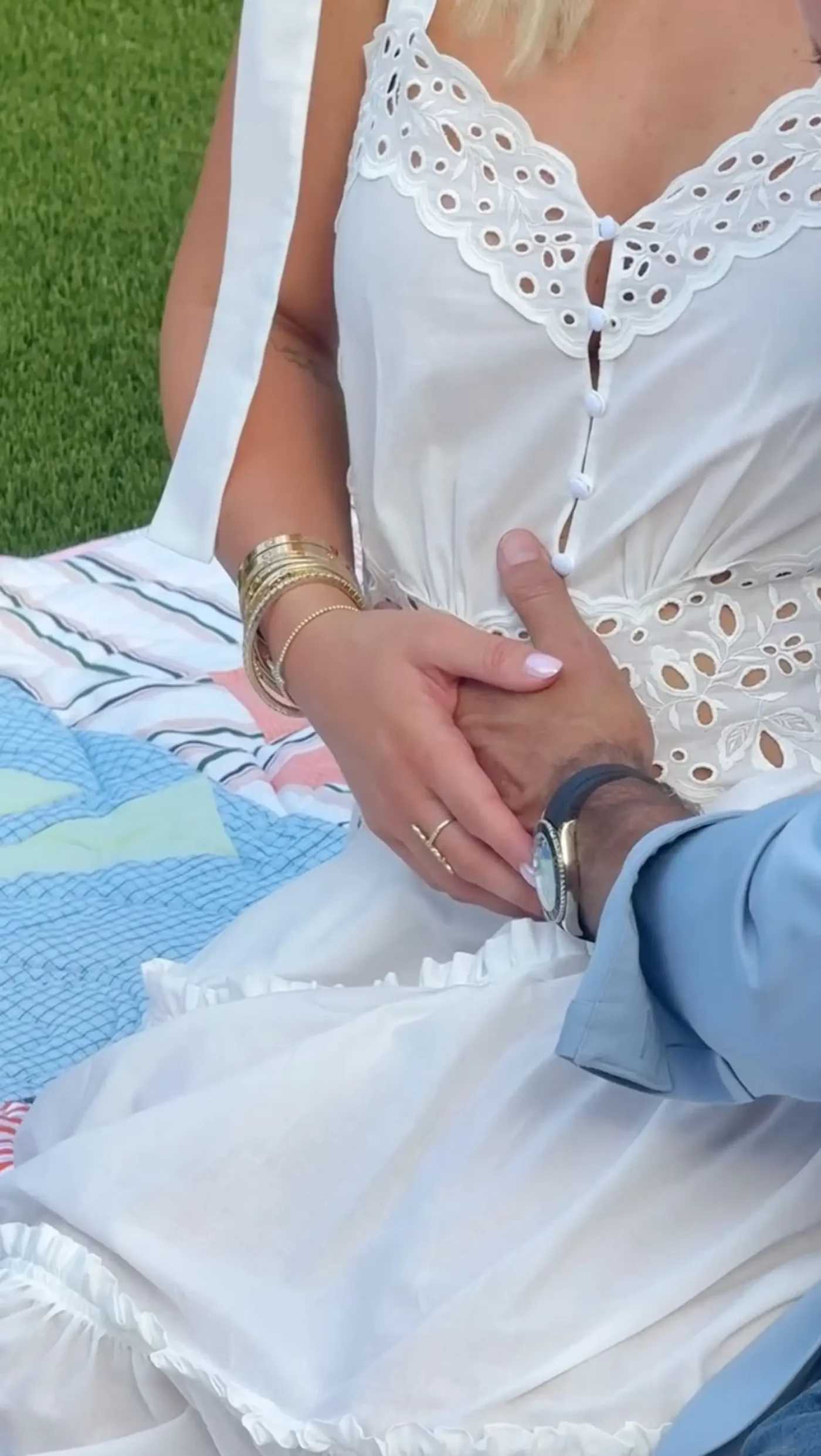 Savannah Chrisley wearing a white dress and holding hands with a man.