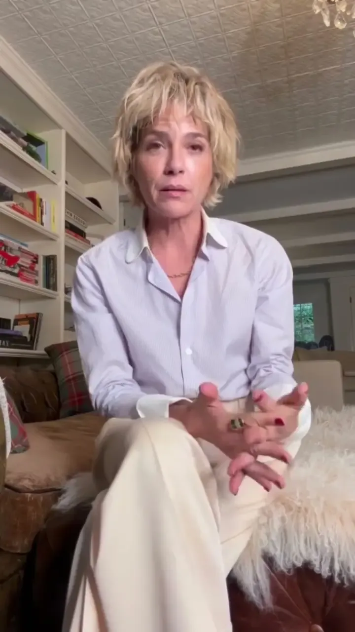 Selma Blair seated and speaking in a room.