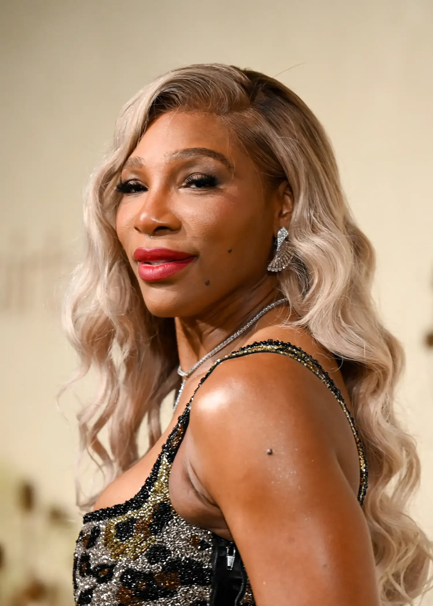 Serena Williams with ice blonde hair in an animal-print dress