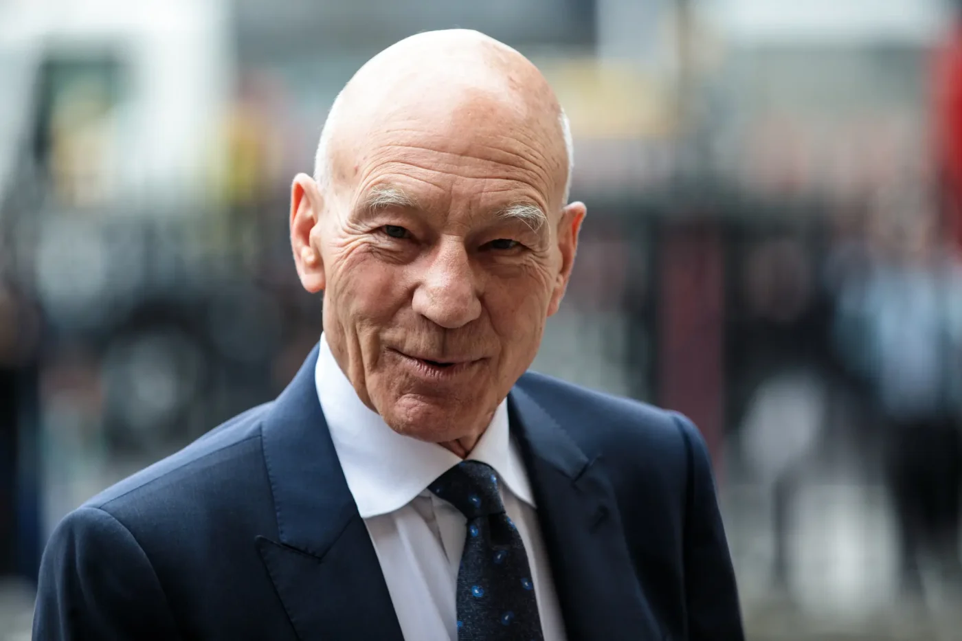 Sir Patrick Stewart wearing a suit and tie.