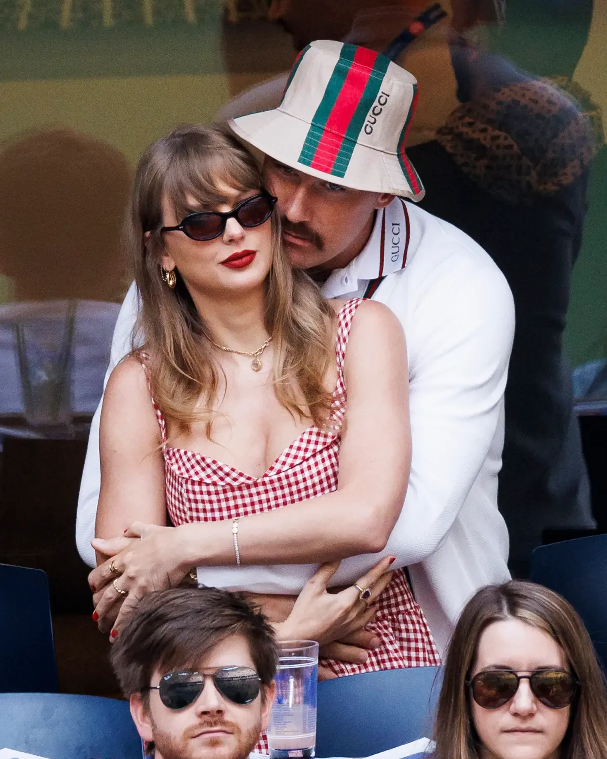 Taylor Swift and Travis Kelce embrace while watching a match at the US Open.