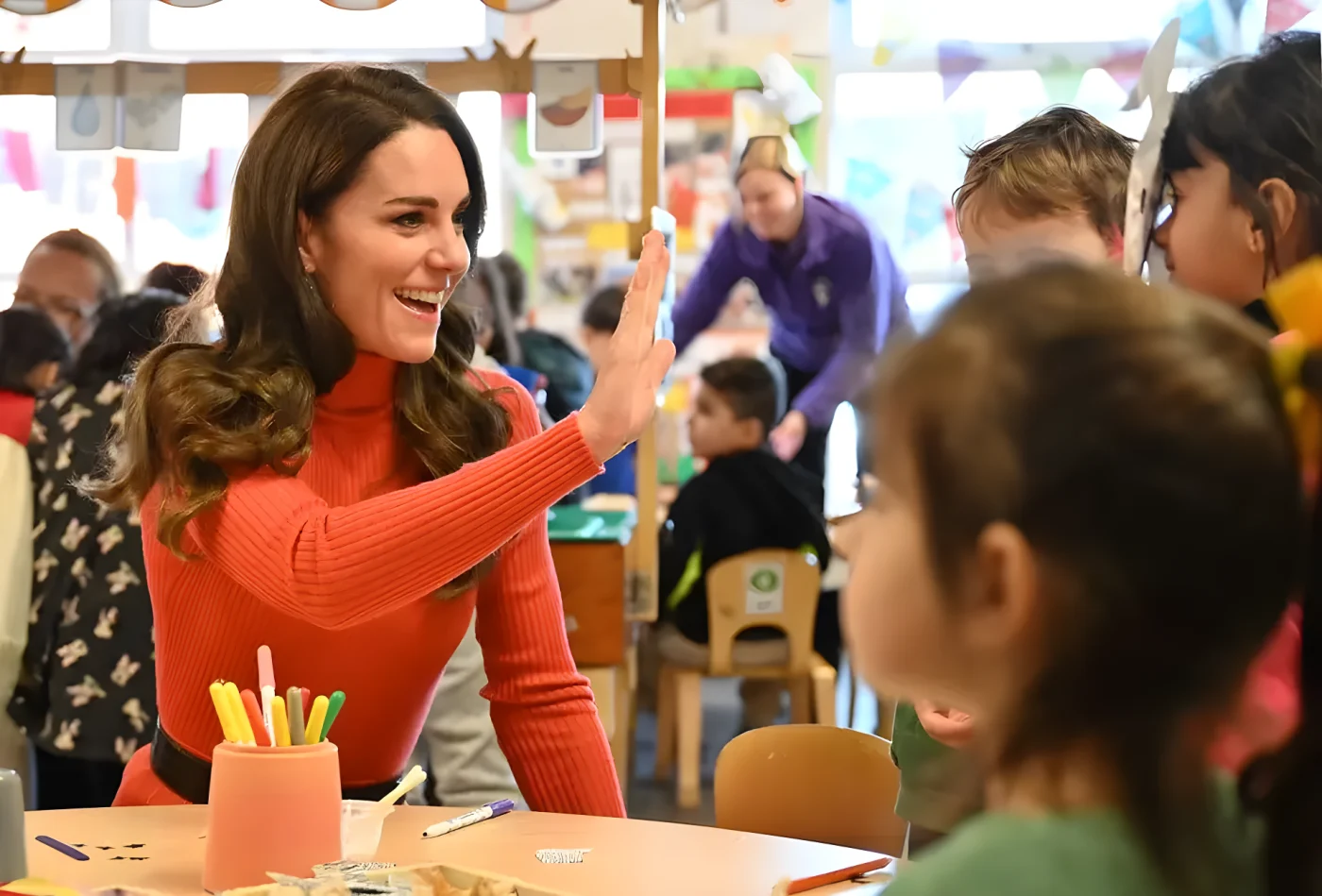 The Princess of Wales waving at children at nursery