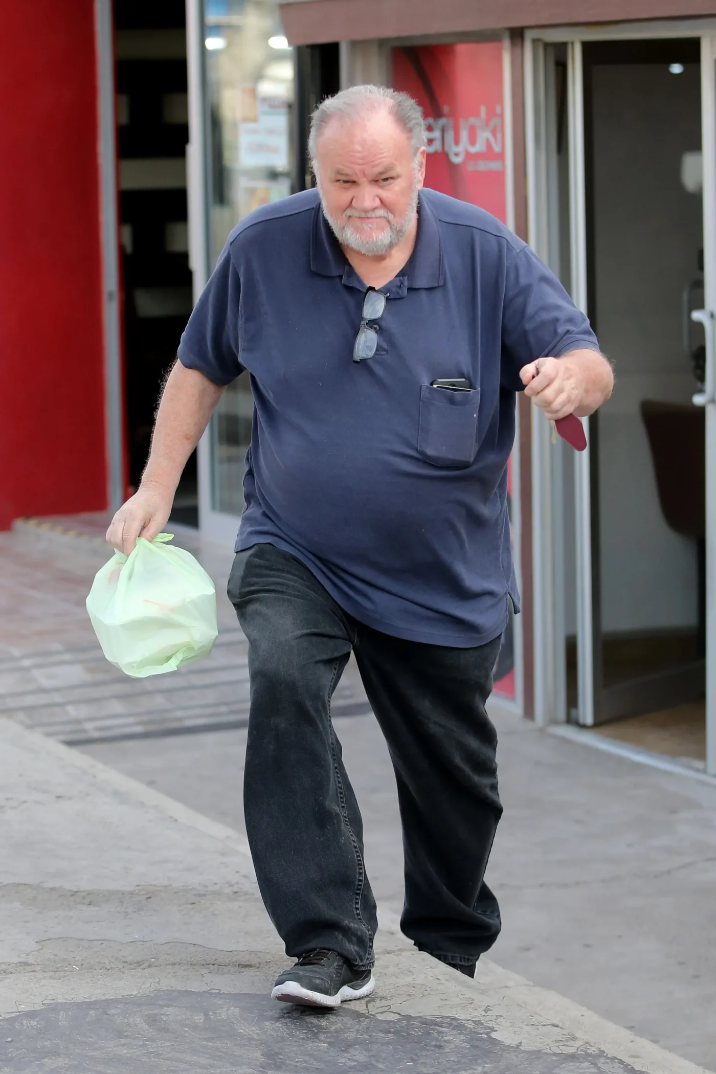 Thomas Markle carries a takeout bag as he exits a restaurant in Rosarito, Mexico.