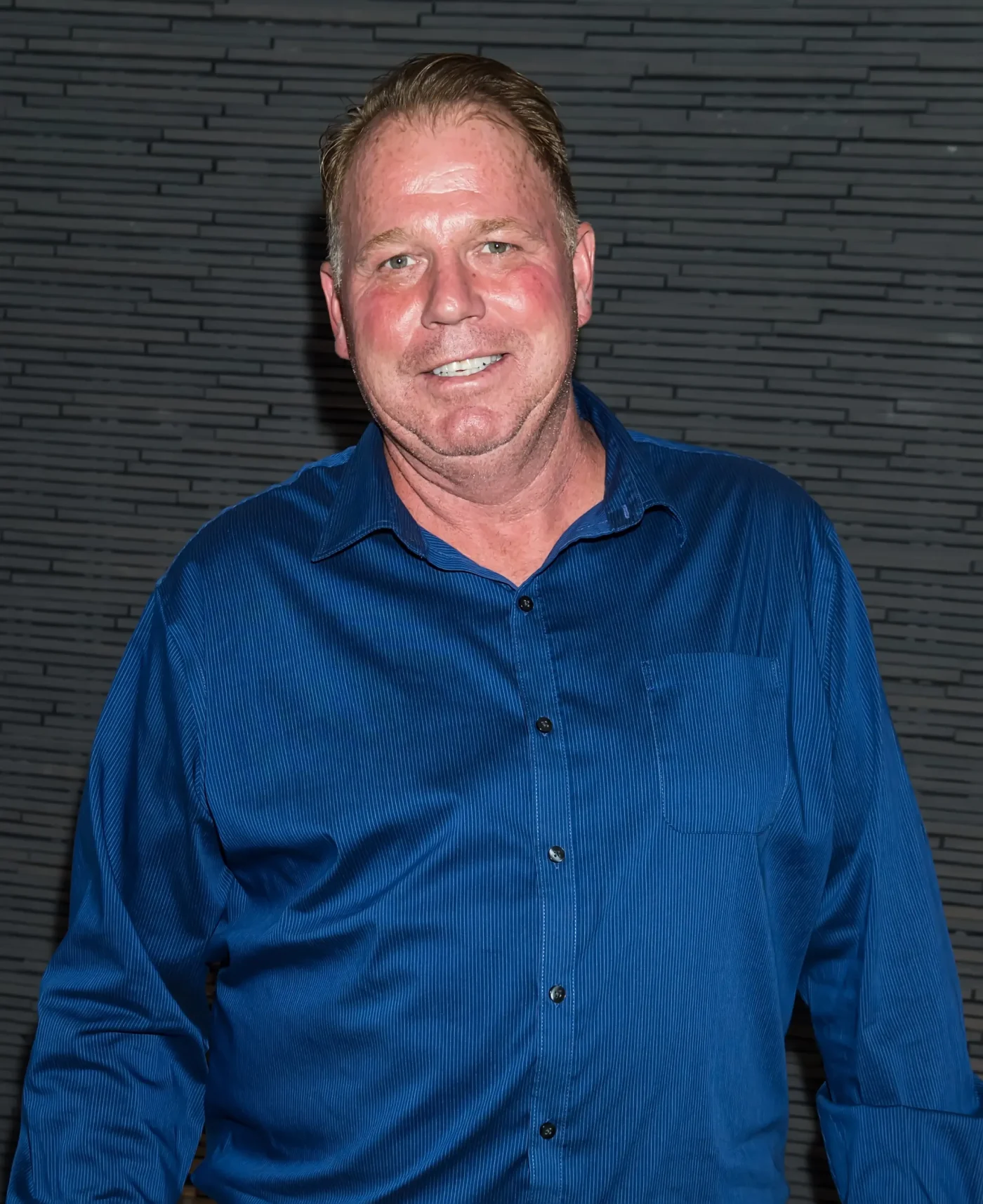Thomas Markle Jr. wearing a blue button-down shirt.
