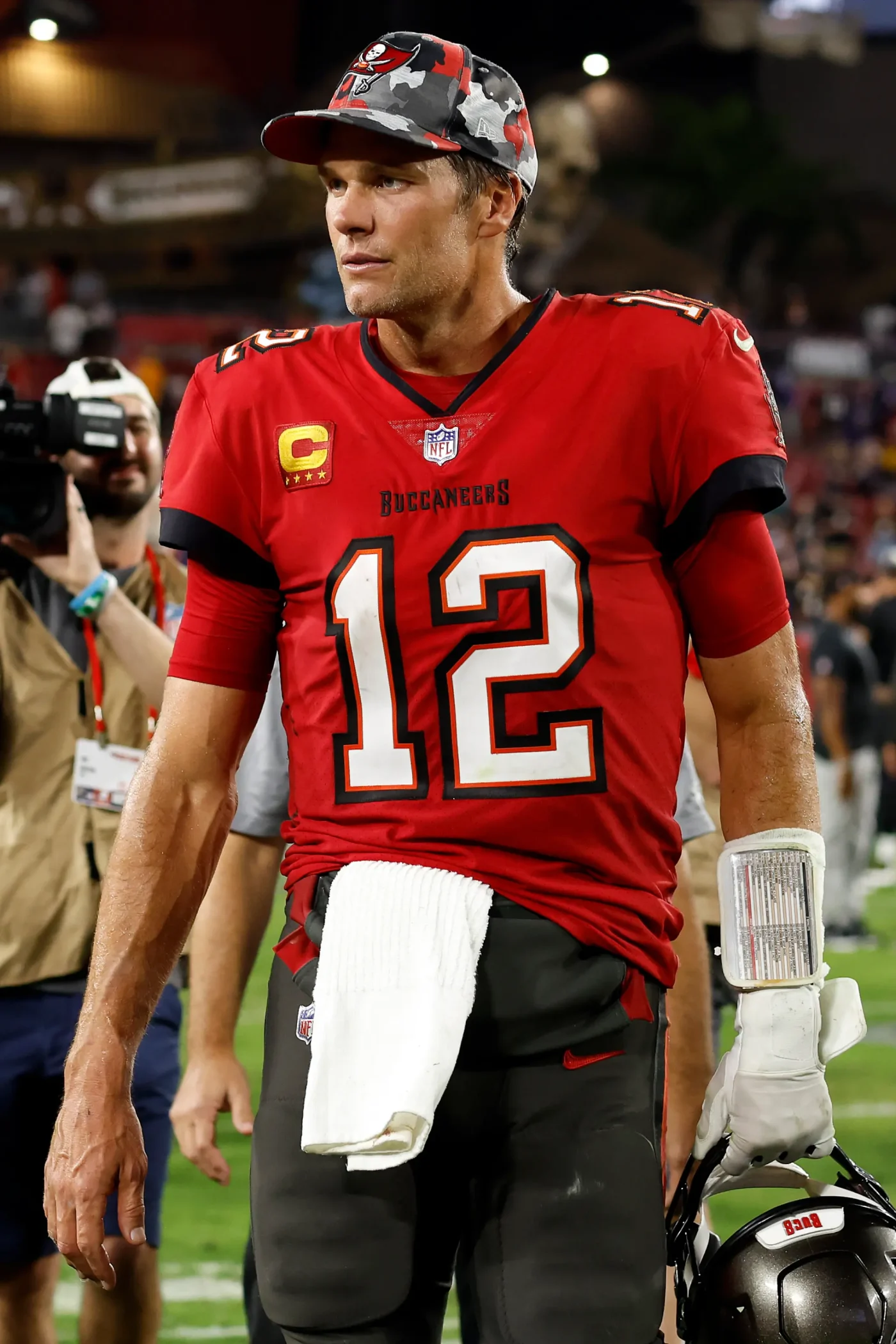 Tom Brady walking off the field in a Tampa Bay Buccaneers uniform.