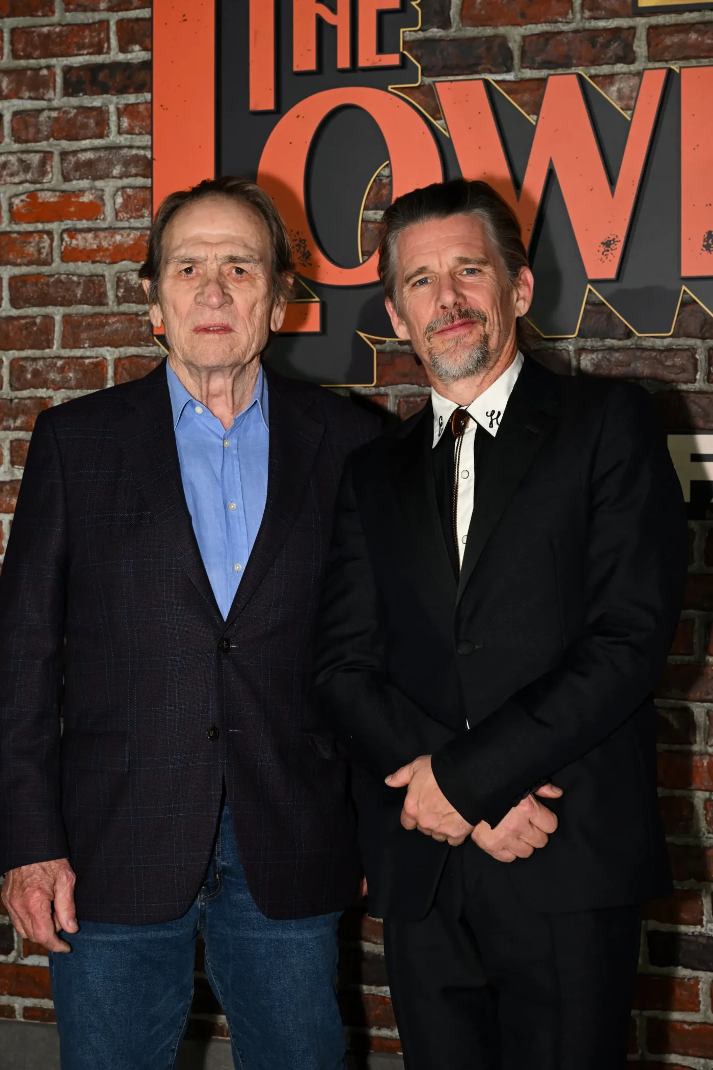 Tommy Lee Jones and Ethan Hawke stand together on the red carpet at FX