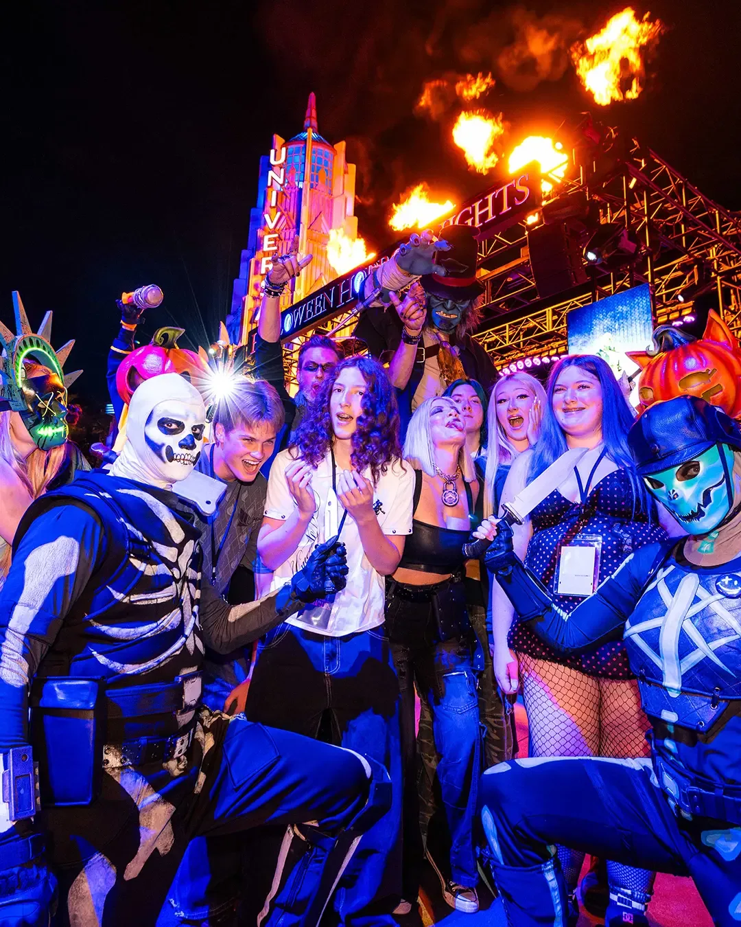 Tori Spelling and her kids pose with scare actors at Halloween Horror Nights.