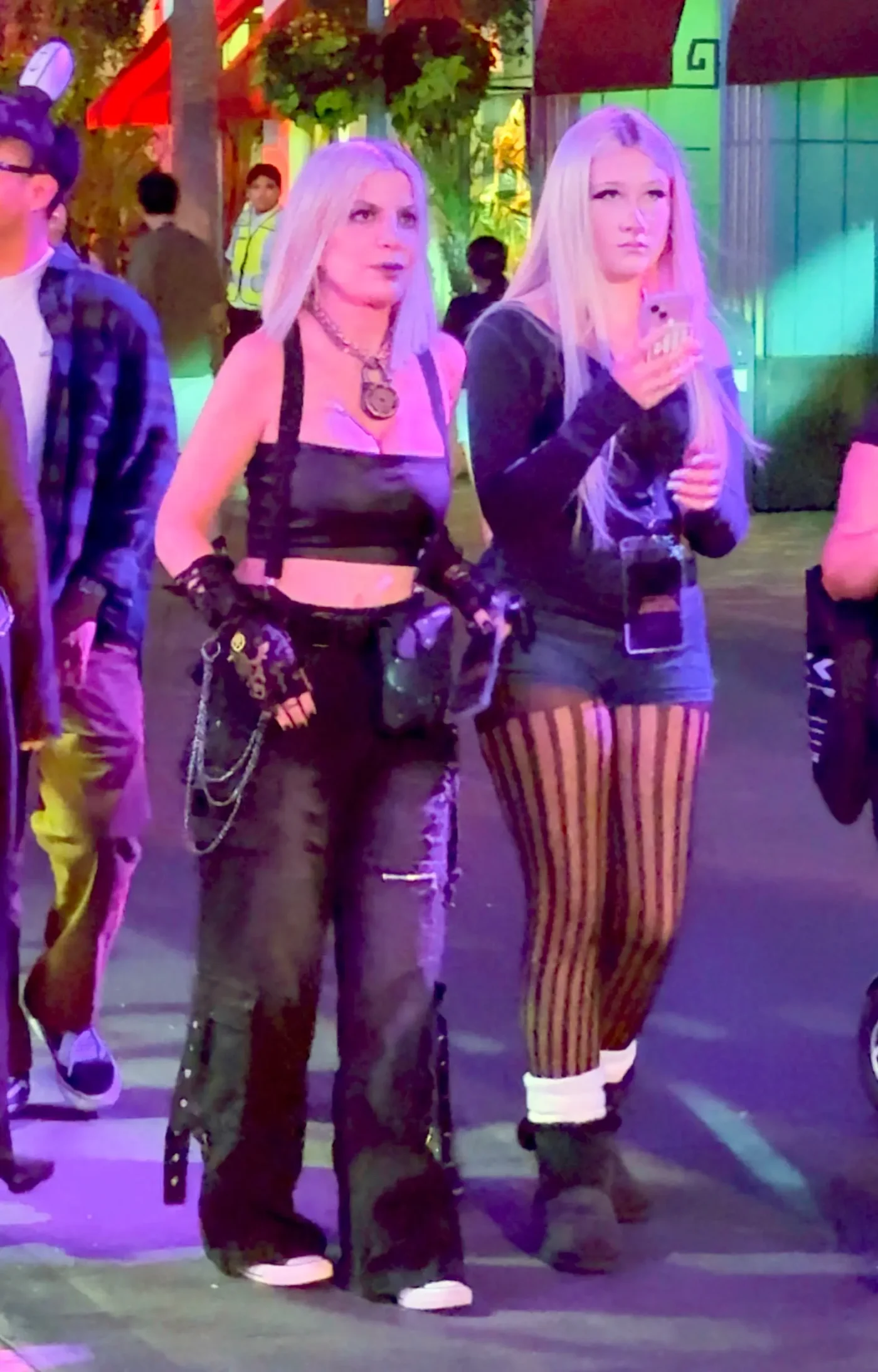 Tori Spelling wearing a black leather tube top, lock choker, and cargo pants during a night out at Universal Horror Nights.