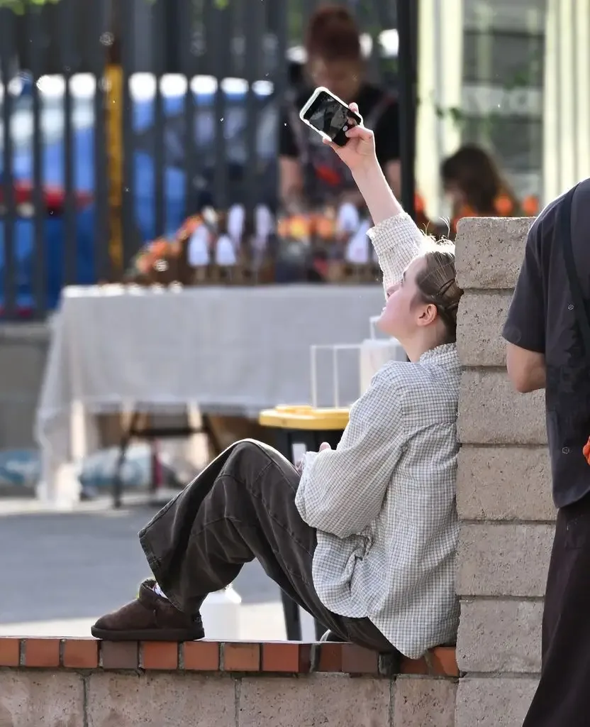 Vivienne was seen taking selfies with her twin brother and they were seen both leaning on a brick pillar