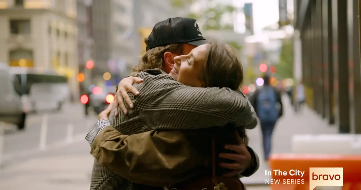 West Wilson and Amanda Batula hugging on a city street.