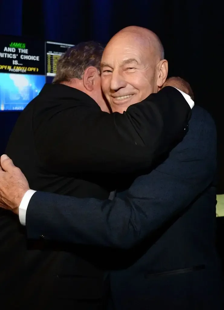 William Shatner (L) embraces Patrick Stewart in 2016