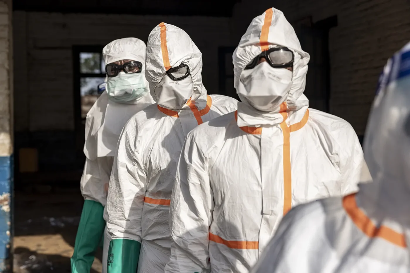 Workers line up to disinfect their protective equipment at General Referral Hospital of Mongbwalu during the Ebola outbreak response in Mongbwalu, Ituri province