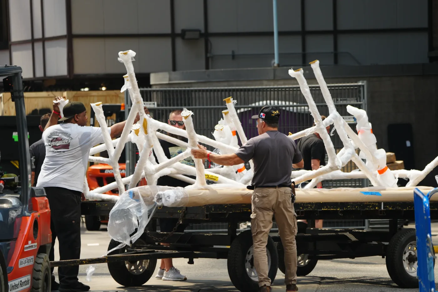Workers move items into Madison Square Garden, where Travis Kelce and Taylor Swift are hosting their wedding.